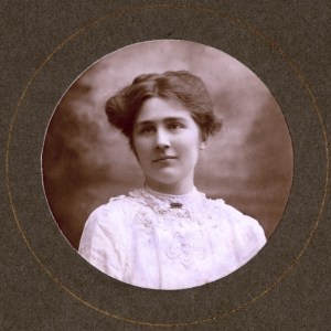 Mary Leigh, c.1910. Photograph, printed, paper, monochrome studio portrait of Mary Leigh, head and shoulders, front profile, circular format, mounted on card; manuscript inscriptions in different hands (on front) 'Mary Leigh (?)' (on reverse) 'Mary Leigh'. Photographer's impression on mount 'Norman, 26 [Tacket] Street, Ipswich'. LSE, 7JCC/O/02/148. 